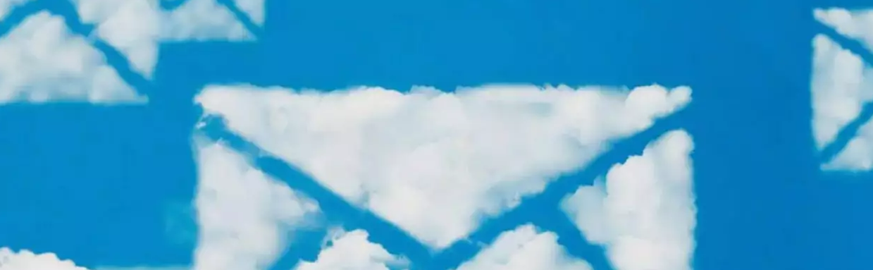 A sky-blue background with clouds shaped like envelopes.