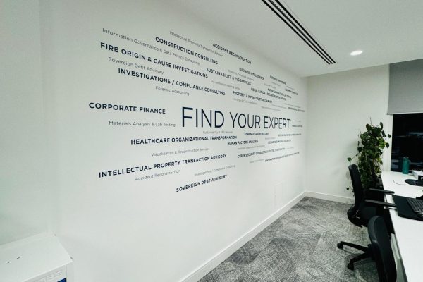 An office wall graphic of buzzwords surrounding the main phrase of "FIND YOUR EXPERT."